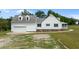 Well-maintained home featuring a metal roof, attached garage, and manicured landscaping at 675 Anderson Creek Rd, Henderson, NC 27537