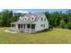 Spacious home with a metal roof, large lawn and a covered front porch at 675 Anderson Creek Rd, Henderson, NC 27537