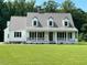 Charming home featuring a metal roof, classic white siding, and a welcoming front porch at 675 Anderson Creek Rd, Henderson, NC 27537