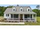 Charming two-story home with a welcoming front porch and American flag at 675 Anderson Creek Rd, Henderson, NC 27537