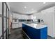 Spacious kitchen with white cabinets, a large island, stainless steel appliances, and a view of stairs at 675 Anderson Creek Rd, Henderson, NC 27537