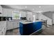 Modern kitchen with white cabinets, a blue island, stainless steel appliances, and tile flooring at 675 Anderson Creek Rd, Henderson, NC 27537