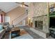 Spacious living room featuring a stone fireplace, high ceilings, and open staircase at 675 Anderson Creek Rd, Henderson, NC 27537