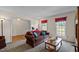 Spacious living room with cozy furniture, large windows, and ample natural light at 675 Anderson Creek Rd, Henderson, NC 27537
