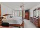 Serene primary bedroom with a four-poster bed, elegant dresser, and a cozy atmosphere at 675 Anderson Creek Rd, Henderson, NC 27537