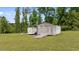 Rustic outbuilding with wooden doors, ramp, and ample storage space at 675 Anderson Creek Rd, Henderson, NC 27537
