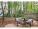 Relaxing backyard with patio seating nestled in lush landscaping and mature trees at 7015 Staghorn Ln, Raleigh, NC 27615