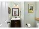 Stylish powder room features a dark wood vanity, modern fixtures and neutral paint at 7015 Staghorn Ln, Raleigh, NC 27615