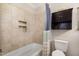 Cozy bathroom features a tiled shower and built in storage above toilet at 7015 Staghorn Ln, Raleigh, NC 27615