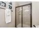 Bathroom showing tiled shower with glass door, towel rack, and black and white decor at 7015 Staghorn Ln, Raleigh, NC 27615