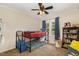 Cozy bedroom with bunkbeds, ceiling fan, carpeted floor and a window letting in natural light at 7015 Staghorn Ln, Raleigh, NC 27615