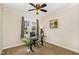 Neutral-toned bedroom with ceiling fan features a carpeted floor, black desk and ample lighting at 7015 Staghorn Ln, Raleigh, NC 27615
