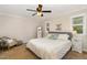 Bright bedroom features a ceiling fan, carpeted floor, large bed and soft, natural light at 7015 Staghorn Ln, Raleigh, NC 27615