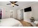 Spacious bedroom features a ceiling fan, closet and a TV mounted to the wall at 7015 Staghorn Ln, Raleigh, NC 27615