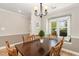 Warm dining room featuring a large wooden table, chairs, and bright window at 7015 Staghorn Ln, Raleigh, NC 27615