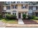 Charming townhome featuring a well-manicured front yard and a welcoming, decorated front door at 7015 Staghorn Ln, Raleigh, NC 27615