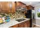 Beautiful kitchen features granite counters, tiled backsplash, stainless steel appliances and wood cabinetry at 7015 Staghorn Ln, Raleigh, NC 27615