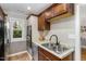 Bright kitchen boasts stainless appliances, double sink, granite counters, and updated fixtures at 7015 Staghorn Ln, Raleigh, NC 27615