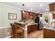Well-lit kitchen featuring wood cabinets, tile backsplash, and a breakfast bar at 7015 Staghorn Ln, Raleigh, NC 27615