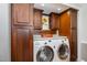 Convenient laundry area with modern washer and dryer, storage cabinets, and counter at 7015 Staghorn Ln, Raleigh, NC 27615