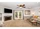 Cozy living room with a fireplace, french doors to backyard, and comfortable furnishings at 7015 Staghorn Ln, Raleigh, NC 27615