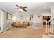 Cozy living room with a view into the kitchen and access to the staircase at 7015 Staghorn Ln, Raleigh, NC 27615