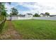 Fenced backyard with shed featuring lush green lawn and trees at 71 Hunters Way, Angier, NC 27501