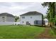 Large backyard featuring lawn, home's exterior, fence, and trampoline at 71 Hunters Way, Angier, NC 27501