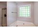Bathroom features a glass block window, shower, and soaking tub at 71 Hunters Way, Angier, NC 27501