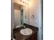 Nice vanity featuring dark granite counter and a framed mirror at 71 Hunters Way, Angier, NC 27501
