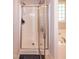 Bathroom with walk-in shower, soaking tub, and glass block window at 71 Hunters Way, Angier, NC 27501