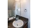 Well-lit bathroom with a dark countertop, a white sink, and bronze fixtures, offering a classic style at 71 Hunters Way, Angier, NC 27501