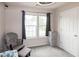 Bright bedroom with large windows, gray curtains, and a chest of drawers for storage at 71 Hunters Way, Angier, NC 27501