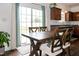 Warm dining area next to the kitchen with a wooden table and sliding glass door to the backyard at 71 Hunters Way, Angier, NC 27501