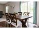 Cozy dining area with a wooden table and chairs, bathed in natural light from the sliding glass door at 71 Hunters Way, Angier, NC 27501