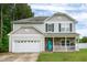 Charming two-story home with gray siding, stone accents, and a bright blue front door at 71 Hunters Way, Angier, NC 27501