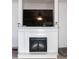 Elegant white fireplace with a dark glass door, perfect for creating a cozy atmosphere at 71 Hunters Way, Angier, NC 27501