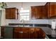 Stylish kitchen with dark wood cabinets and stainless steel appliances, offering a modern touch at 71 Hunters Way, Angier, NC 27501