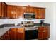 Contemporary kitchen showcasing stainless steel appliances and beautiful dark wood cabinets at 71 Hunters Way, Angier, NC 27501