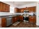 Well-appointed kitchen featuring stainless steel appliances and dark wood cabinetry at 71 Hunters Way, Angier, NC 27501