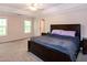 Spacious main bedroom with a tray ceiling, ceiling fan, and large windows for natural light at 71 Hunters Way, Angier, NC 27501