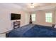 Main bedroom with ceiling fan, decorative shelving, and large windows at 71 Hunters Way, Angier, NC 27501