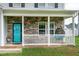Inviting porch with stone accents, white railings, and a hanging chair for relaxed outdoor living at 71 Hunters Way, Angier, NC 27501