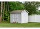 Shed in fenced backyard featuring green lawn and surrounding trees at 71 Hunters Way, Angier, NC 27501