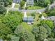 Overhead shot of a blue home with a green yard and treed lot, plus a deck for outdoor enjoyment at 7209 Halstead Ln, Raleigh, NC 27613