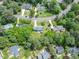 High angle view showcases a blue home among mature trees in a peaceful neighborhood at 7209 Halstead Ln, Raleigh, NC 27613