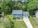 Aerial view of a two story home with a two car garage and large front yard landscaped with mature trees at 7209 Halstead Ln, Raleigh, NC 27613