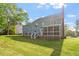 Two-story home with spacious backyard, deck, screened porch, and mature trees offering a serene outdoor space at 7209 Halstead Ln, Raleigh, NC 27613