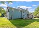 Two-story home with a spacious backyard, deck, screened porch, and mature trees, offering a serene outdoor space at 7209 Halstead Ln, Raleigh, NC 27613