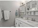 Bright bathroom featuring double sinks, white cabinets, and ample storage space at 7209 Halstead Ln, Raleigh, NC 27613